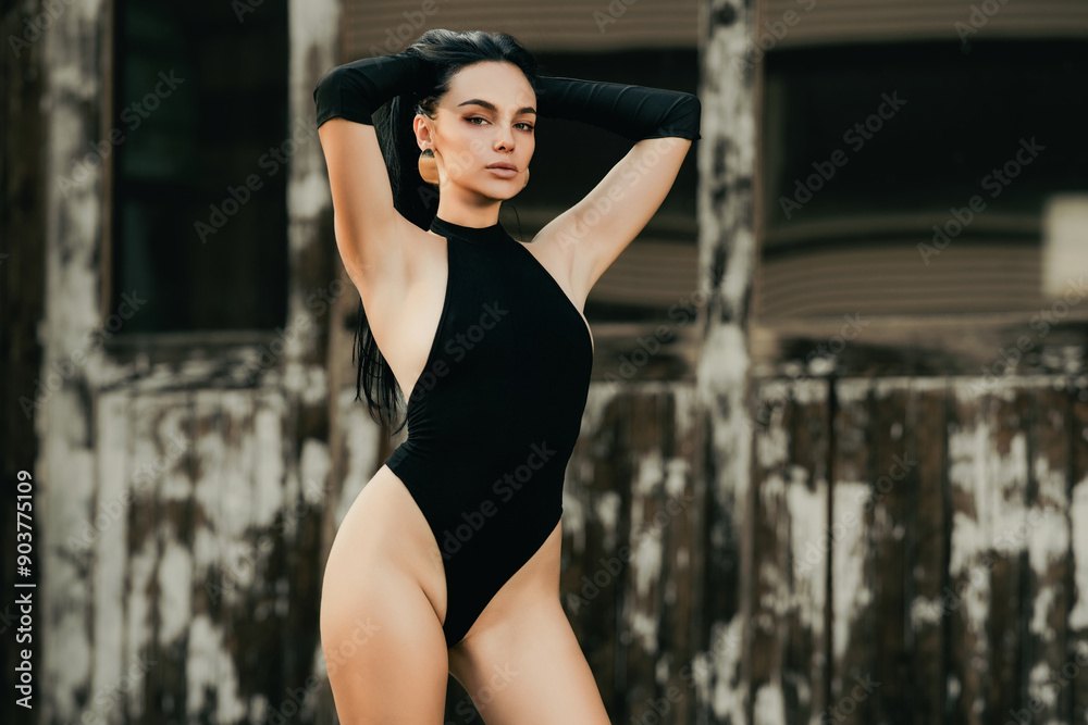 Fototapeta premium Girl posing near luxury american retro car outdoor. Sexy sensual hispanic women and fashion concept. Fashion sexy model posing near retro car outdoor. Glamour trendy fashion woman. Beauty trends.