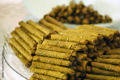 Obraz na płótnie Homemade stuffed vine leaves are arranged in a row on the table, w salonie