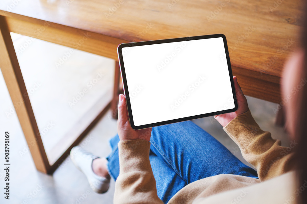 Top view mockup image of a woman holding digital tablet with blank desktop screen