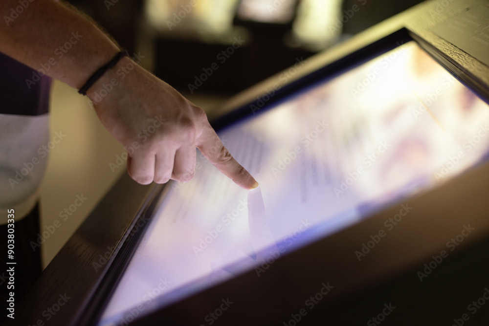 Man hand using touchscreen display of kiosk, close up view of male finger touching screen Man hand using touchscreen display of kiosk, close up view of male finger touching screen