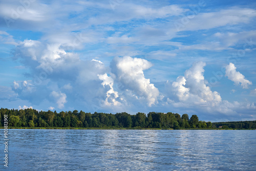 view from the boat on the river with waves and blue sky with white clouds  photo