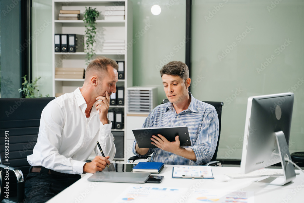 Male discussing new project with male colleague. .Caucasian man talking Male discussing new project with male colleague. .Caucasian man talking