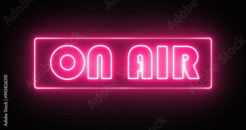 A neon light that glows pink to indicate that it is on air.