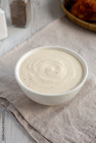 Homemade Alabama White Sauce for BBQ Chicken Drumsticks and Wings, side view.