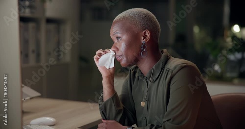 Black woman, blowing nose and flu with tissue in office for viral disease, bacteria and sinus congestion. Business, person and sick with computer at night for virus, info and infection of LB.1 covid