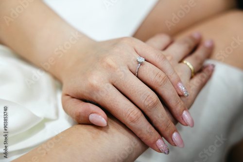 Elegant hands with a beautiful diamond ring and delicate nail art