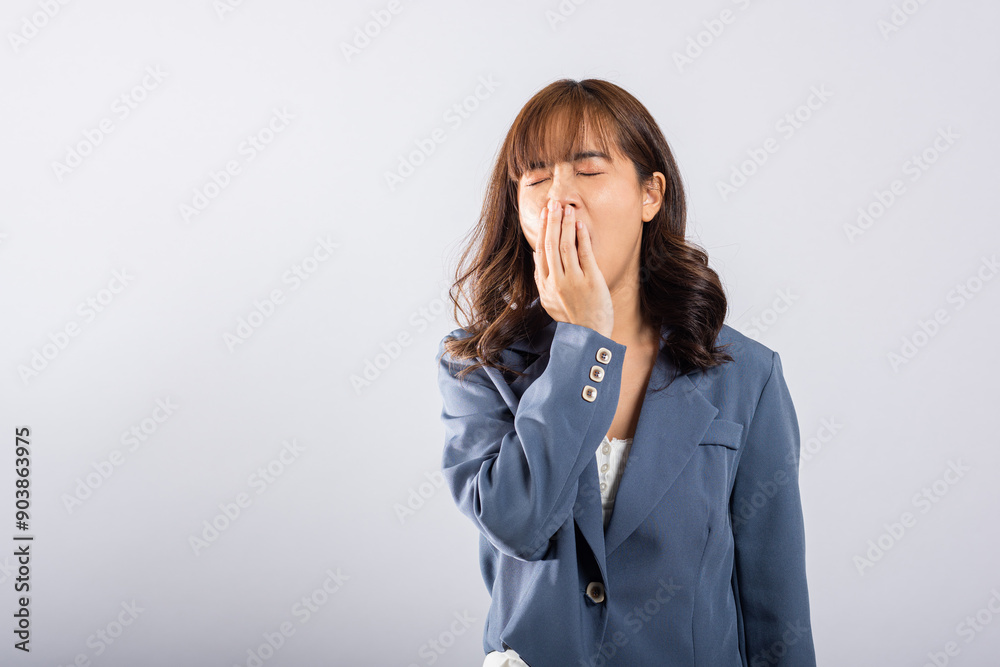 Portrait Asian beautiful young business woman emotions tired and sleepy her yawning covering mouth open by hand, studio shot isolated on white background, Female insomnia concept with copy space Portrait Asian beautiful young business woman emotions tired and sleepy her yawning covering mouth open by hand, studio shot isolated on white background, Female insomnia concept with copy space