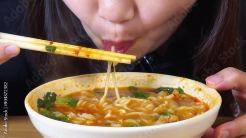 Enjoying a Bowl of Spicy Ramen photo