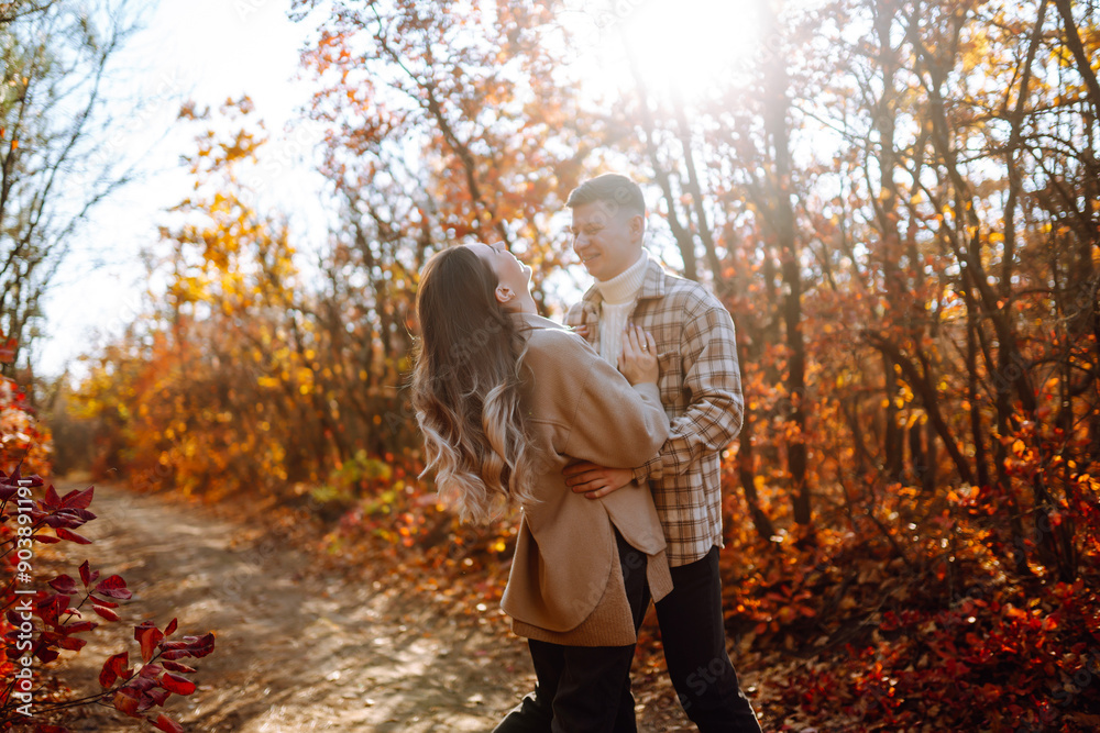 Couple in love are walking outdoor and enjoying the autumn weather in the forest. Concept of vacation, weekend, love. Couple in love are walking outdoor and enjoying the autumn weather in the forest. Concept of vacation, weekend, love.
