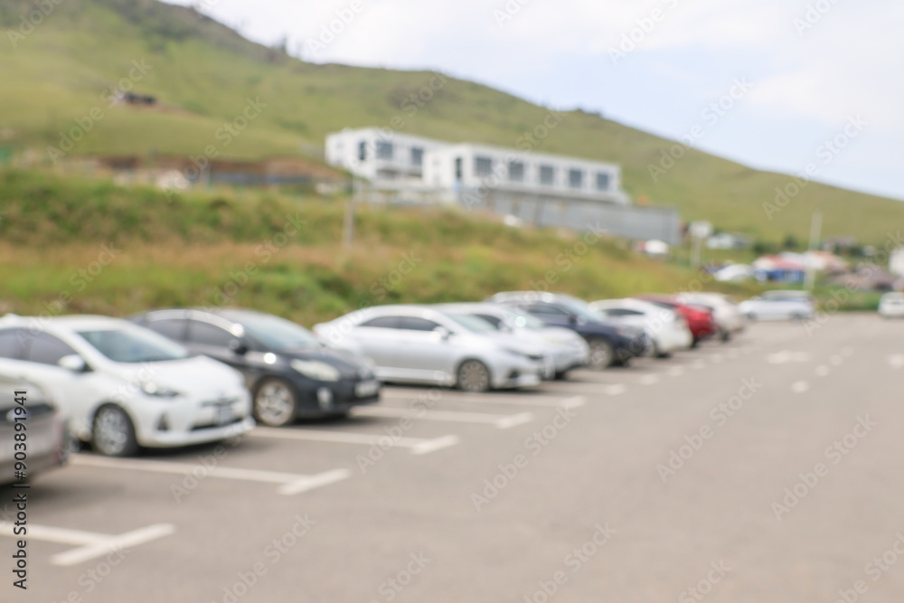 Blur outdoor car park in the official place and the hot sun. Cars parked in a row. blur and abstract background Blur outdoor car park in the official place and the hot sun. Cars parked in a row. blur and abstract background