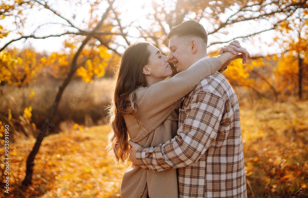 Couple in love are walking outdoor and enjoying the autumn weather in the forest. Concept of vacation, weekend, love. Couple in love are walking outdoor and enjoying the autumn weather in the forest. Concept of vacation, weekend, love.