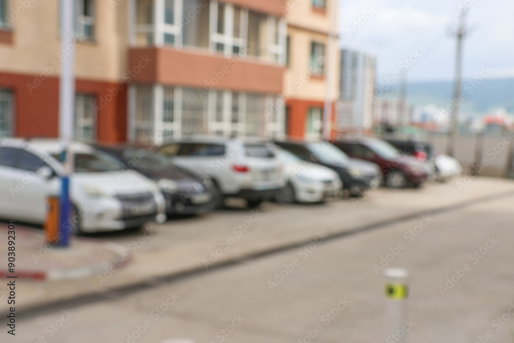 Blur outdoor car park in the official place and the hot sun. Cars parked in a row. blur and abstract background Blur outdoor car park in the official place and the hot sun. Cars parked in a row. blur and abstract background