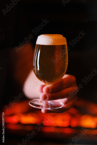 A glass of beer in a man's hand