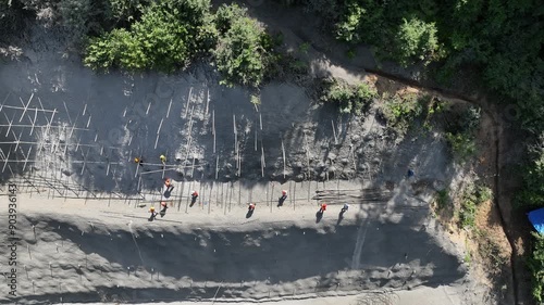 Rikoti, Georgia - July 17 2024: aerial view of cranes and bridge foundation pillars on construction site of new highway road project built by chinese builders in Rikoti bypass photo