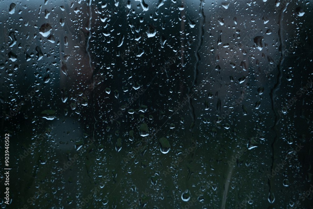 Water drops on glass window with autmn forest background Water drops on glass window with autmn forest background