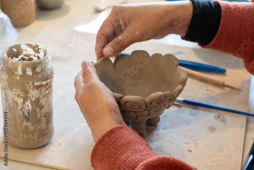 shape clay with hands	 photo