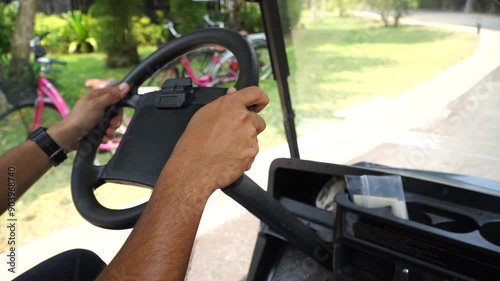 man driving an electric golf cart in a resort