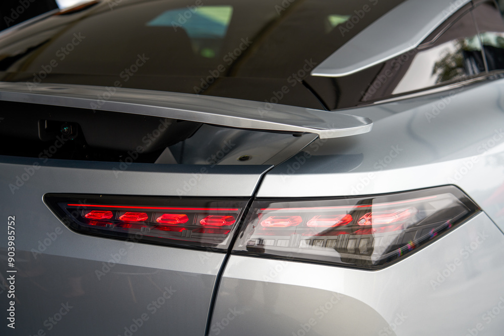 Fototapeta premium Close-up of the lights of a new energy electric car