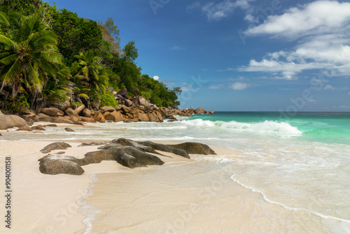 Palm trees and granite rocks at Anse Georgette scenic beach in Praslin island, Seychelles photo