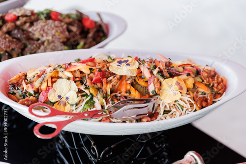 Obraz na płótnie Colorful Mixed Salad with Edible Flowers and Nuts on a White Serving Platter w salonie