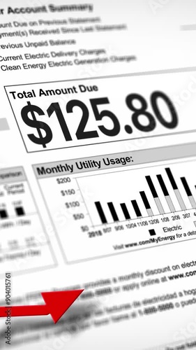 A close-up vertical view of a household electric utility bill rising. Increasing cost of living concept.  	