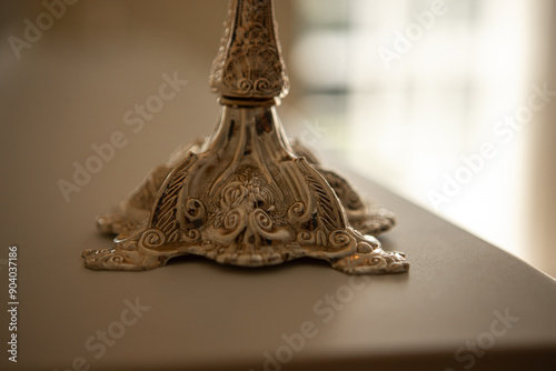 a silver candelabra with a white candles on top of it in a room photo