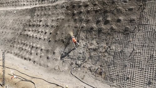 Rikoti, Georgia - July 17 2024: aerial view of cranes and bridge foundation pillars on construction site of new highway road project built by chinese builders in Rikoti bypass photo