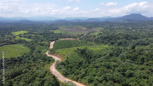 Aerial view of the opening or construction of the alternative road from Batulicin to Banjarbaru, South Kalimantan, surrounded by beautiful mountain views. photo