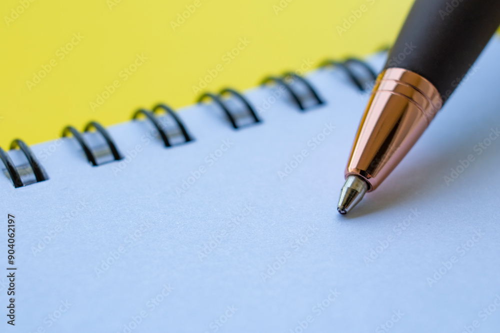 Close up of pen on white note pad with customizable space for text or ideas. Copy space concept Close up of pen on white note pad with customizable space for text or ideas. Copy space concept