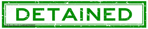 Grunge green detained word square rubber stamp in white background
