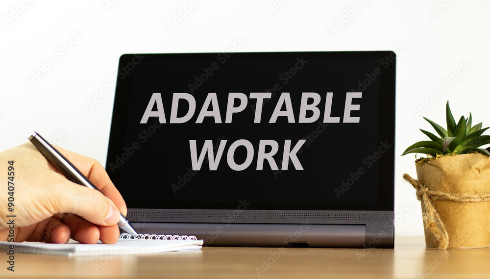 Adaptable work symbol. Concept words Adaptable work on beautiful black pad. Beautiful white background. Businessman hand. Business Adaptable work concept. Copy space. Adaptable work symbol. Concept words Adaptable work on beautiful black pad. Beautiful white background. Businessman hand. Business Adaptable work concept. Copy space.