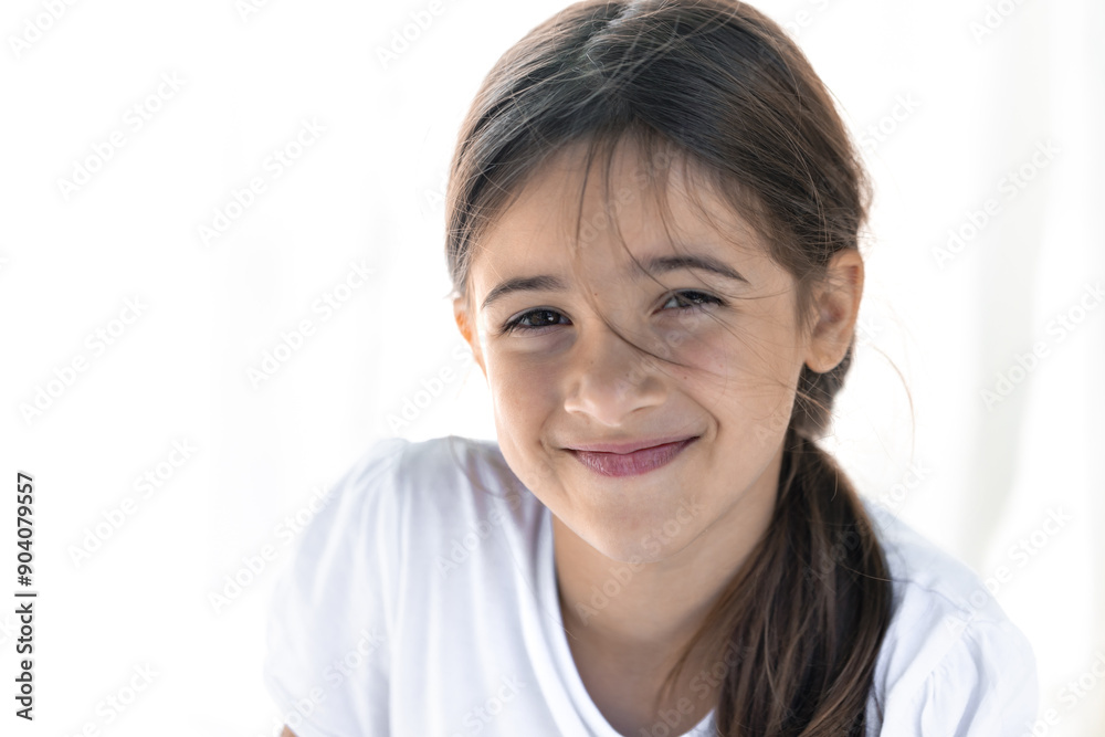 Portrait of a shy smiling teenage girl on a white background, close-up. Portrait of a shy smiling teenage girl on a white background, close-up.