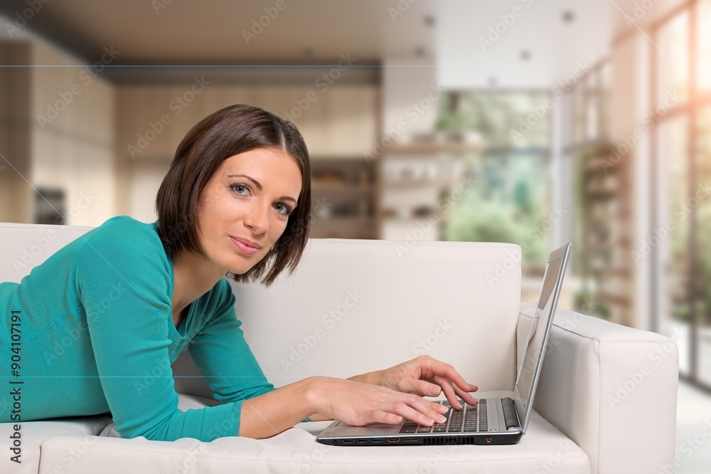 Portrait of happy young woman using laptop at home Portrait of happy young woman using laptop at home