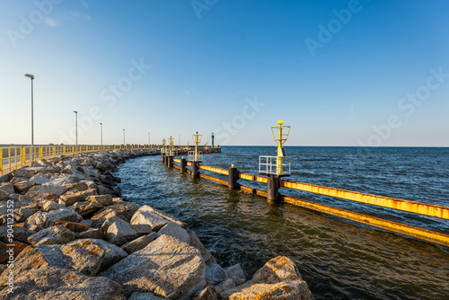 Obraz na płótnie View from the breakwaters at the port in Łeba. Beautiful sunny holiday day. Baltic Sea. Entrance to the port. w salonie