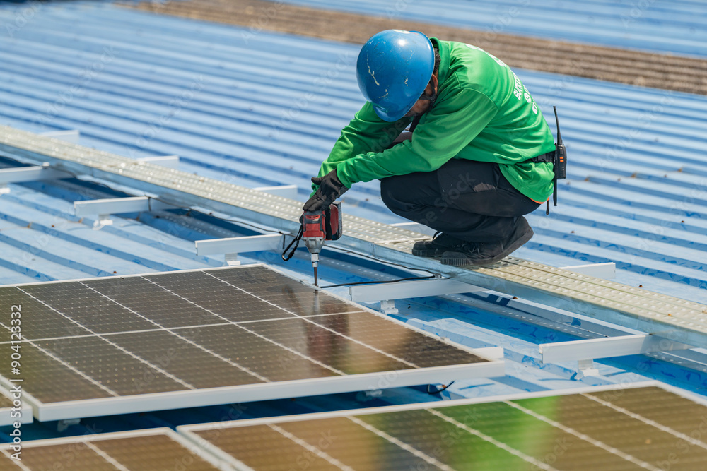 Worker Technicians are working to construct solar panels system on roof. Installing solar photovoltaic panel system. Men technicians walking on roof structure to check photovoltaic solar modules. Worker Technicians are working to construct solar panels system on roof. Installing solar photovoltaic panel system. Men technicians walking on roof structure to check photovoltaic solar modules.