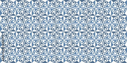 A repeating geometric pattern with blue and white shapes in a modern abstract design, perfect for background and surface design.