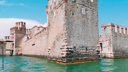 fortress castle of Sirmione seen from the boat on Lake Garda. High quality 4k footage photo