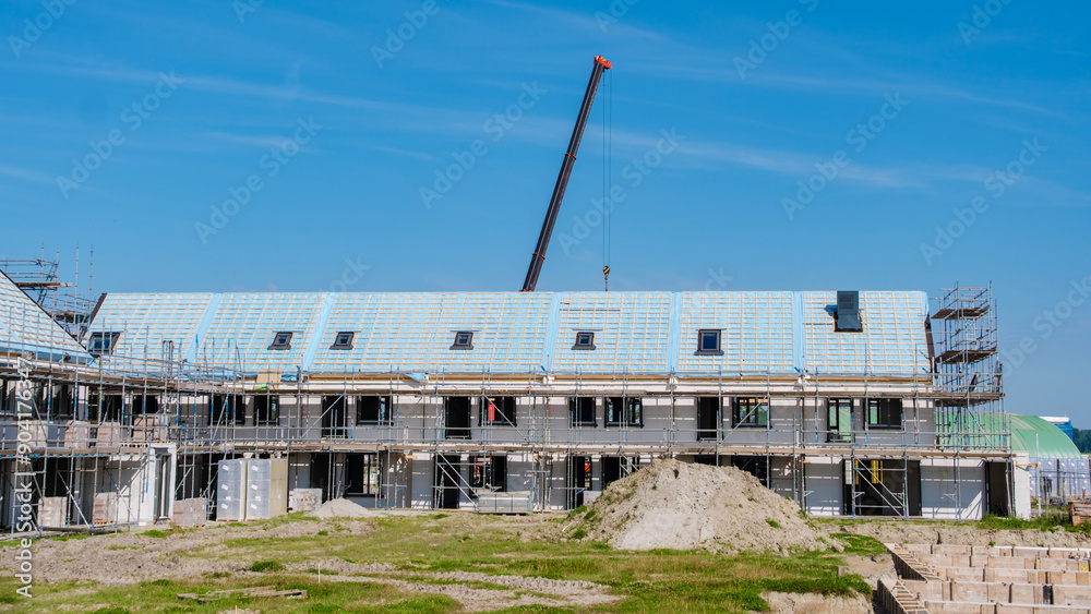 Modern Family Homes Rise at Dutch Suburban Construction Site Under Clear Blue Sky Modern Family Homes Rise at Dutch Suburban Construction Site Under Clear Blue Sky