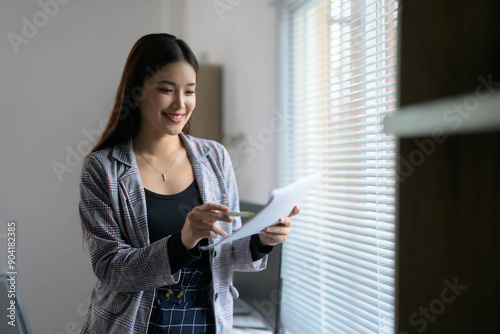Young Professional Woman Working on Documents in a Modern Office with Natural Light Free Download Young Professional Woman Working on Documents in a Modern Office with Natural Light - GFXLoad