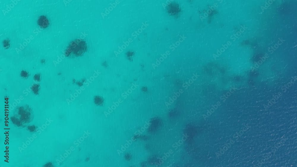 Tropical south pacific ocean water in different shades of blue, turquoise, and azure surround the island of Bora Bora. Aerial drone view pans up to reveal dozens of sailboats. Tropical south pacific ocean water in different shades of blue, turquoise, and azure surround the island of Bora Bora. Aerial drone view pans up to reveal dozens of sailboats.