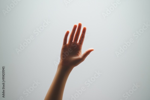 A raised hand reaches out against a soft, neutral background, symbolizing connection and communication