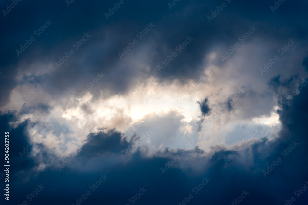 Dark and Dramatic Storm Clouds framing a clear sky Area Background Dark and Dramatic Storm Clouds framing a clear sky Area Background