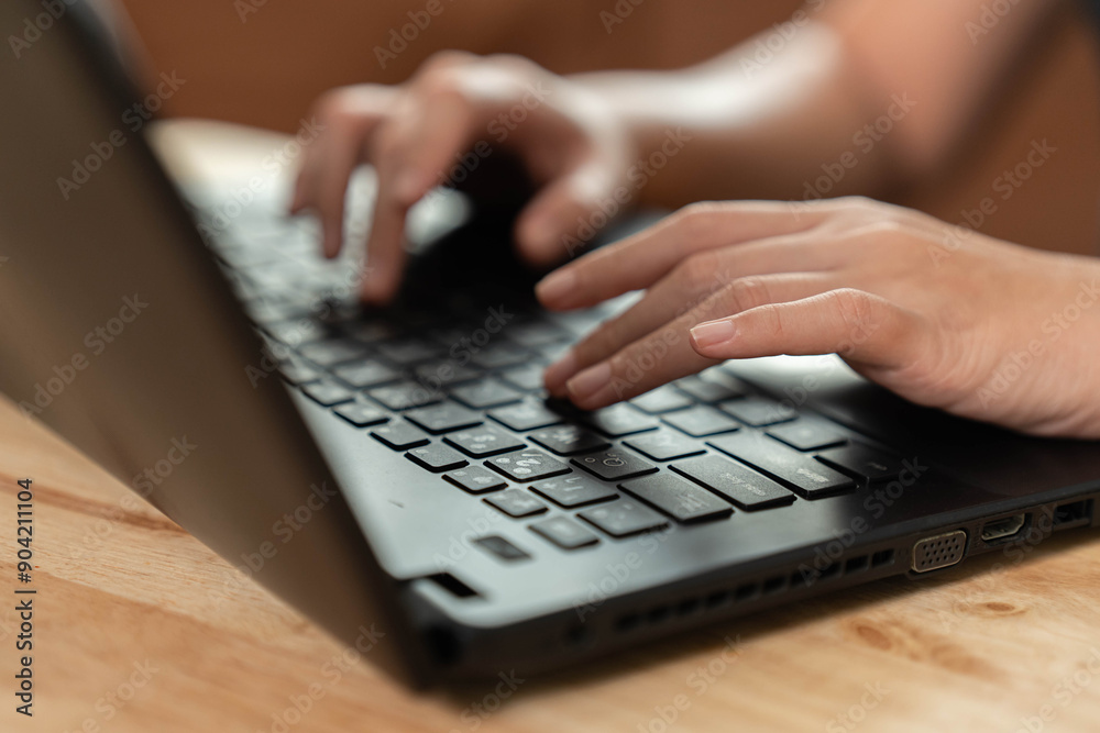 Hand typing at computer keyboard