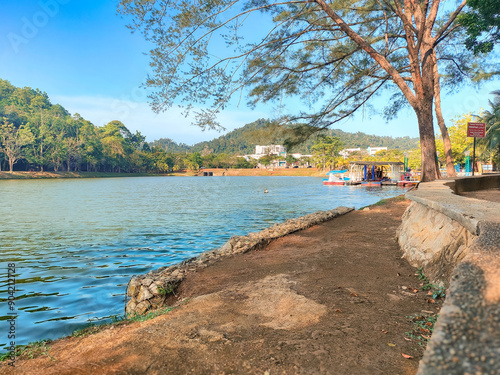 Beutiful landscape with trees, blue sky and wavy lake in the morning at Taman Bandar Kuantan, Pahang, Malaysia photo