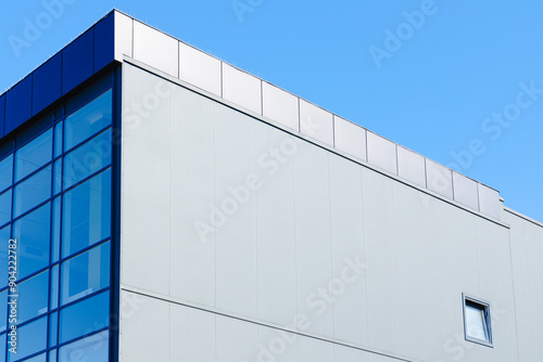 factory office architecture building exterior outdoor facade blue wall and window with blue sky background with empty copy space for text