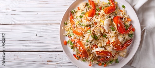 Top view of crab fried rice served in crab shells on a white plate set against a white wooden table background featuring ample copy space image photo