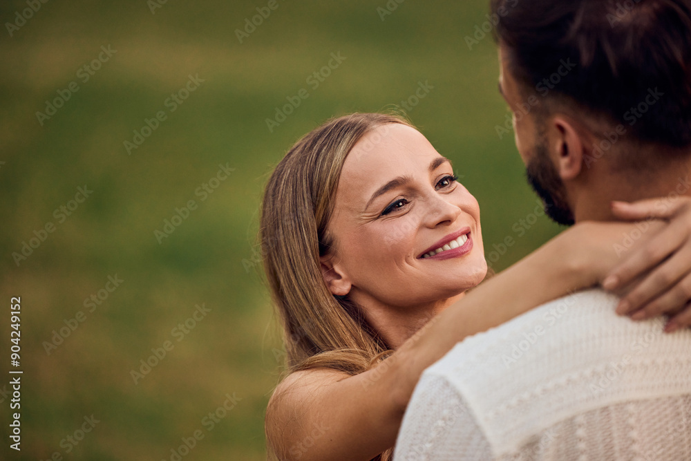 A lovely female smiling and looking at her male partner, at the park. A lovely female smiling and looking at her male partner, at the park.