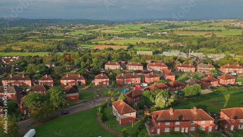 Yorkshire's housing district: Aerial drone shot of red brick council housing in the morning sun, showcasing residents and active streets in the UK. photo