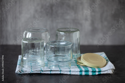 Sterilised preserving jars on a tea towel, recycled dishes photo