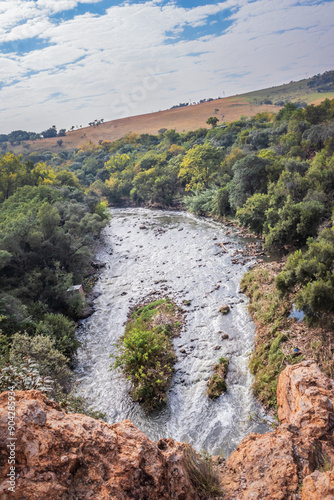 View of a Hennops Hiking Trail, with river running through, small bridge and cableway over the river, Hartbeespoort, Johannesburg, South Africa photo